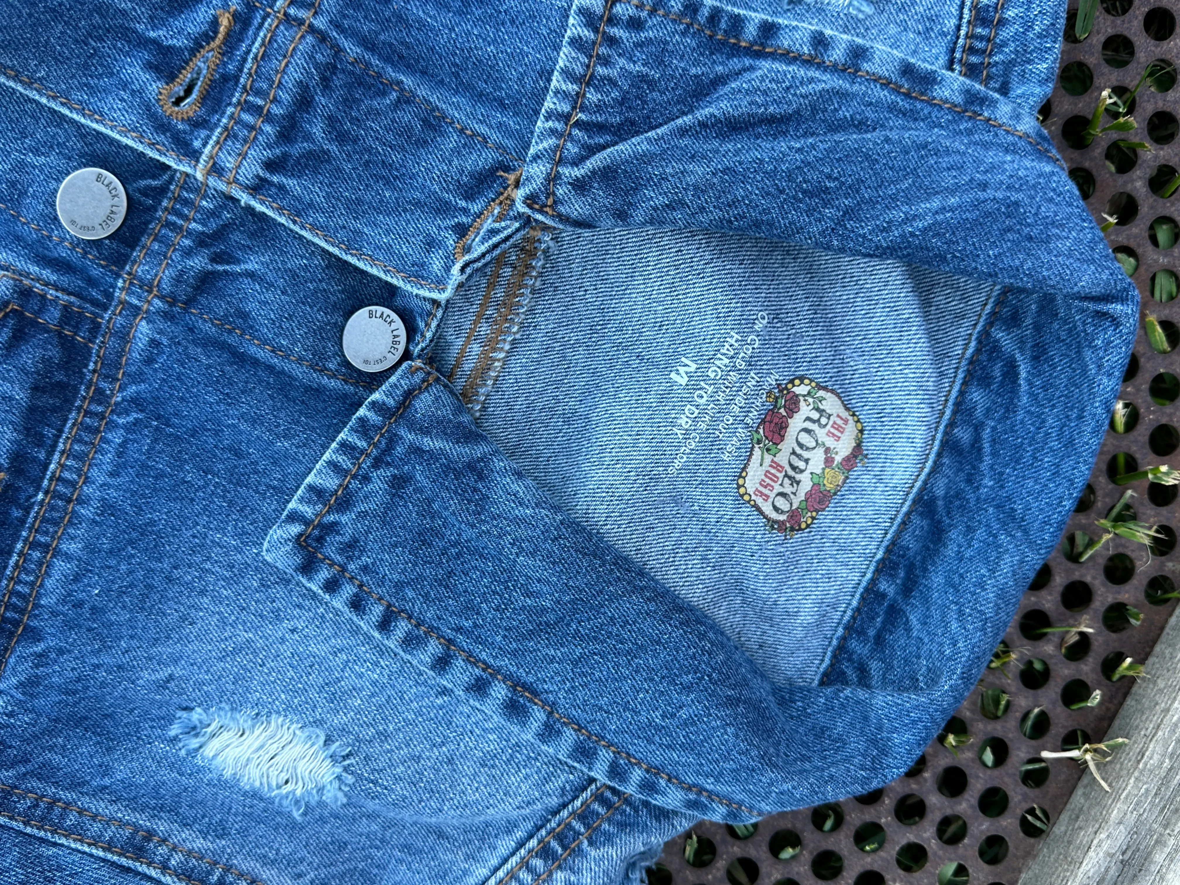 Denim jacket with Squash Blossom and tooled sides.