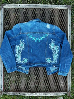 Denim jacket with Squash Blossom and tooled sides.