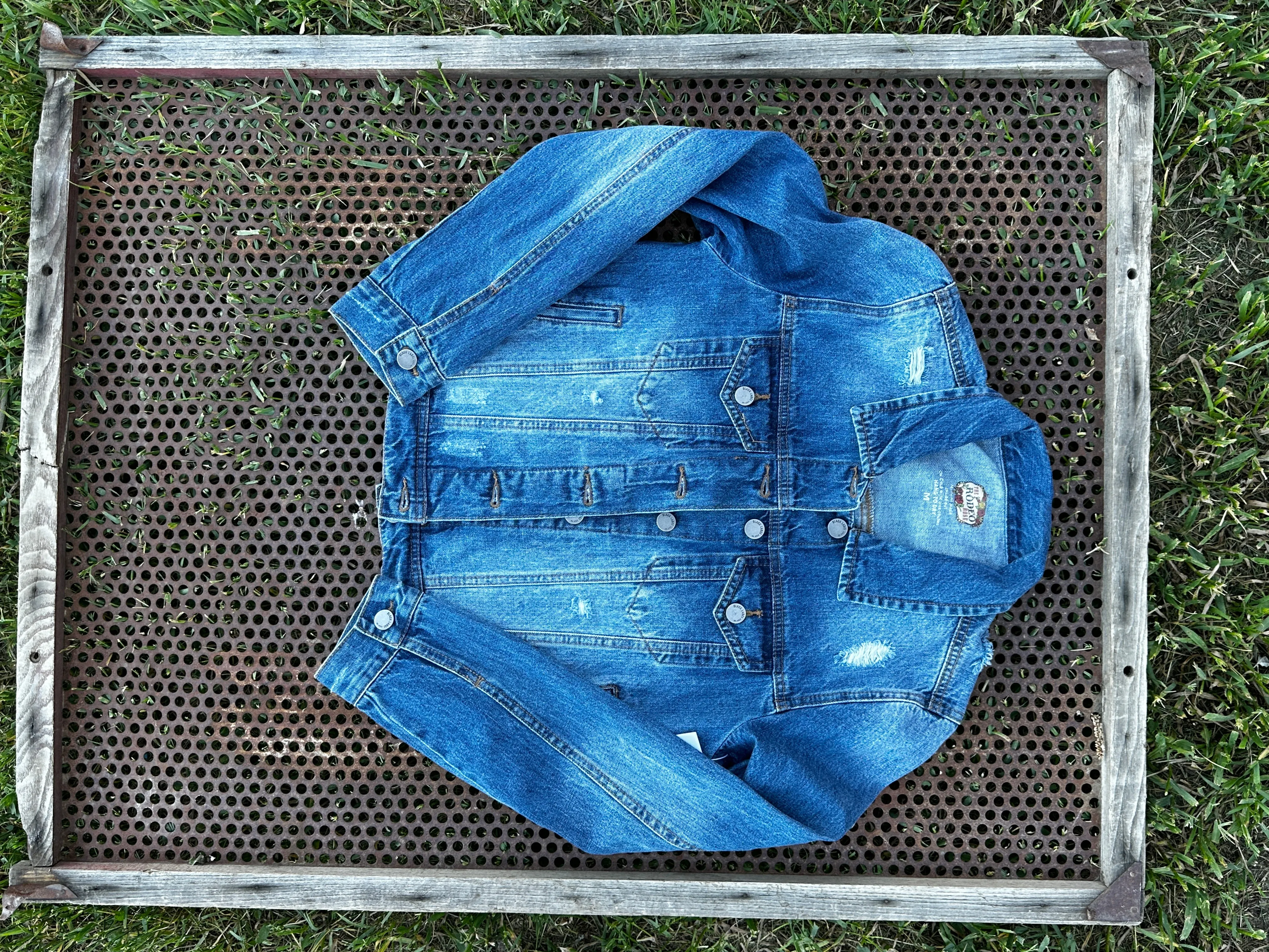 Denim jacket with Squash Blossom and tooled sides.