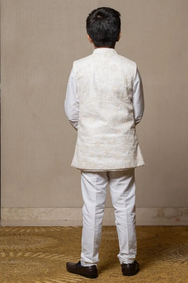 Ivory embroidered Nehru jacket paired with a classic white shirt and pants for an elegant traditional look.