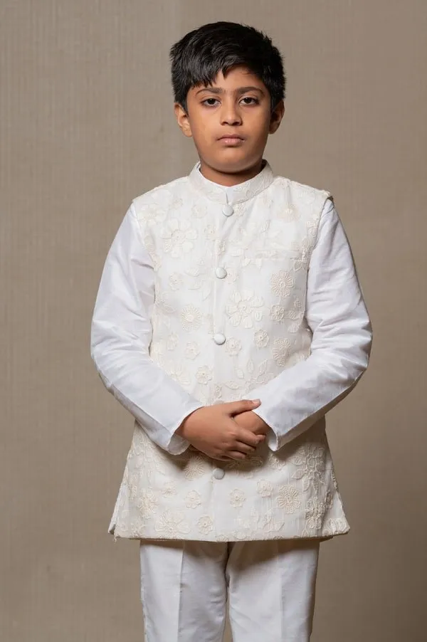 Ivory embroidered Nehru jacket paired with a classic white shirt and pants for an elegant traditional look.