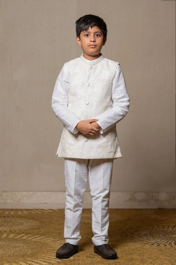 Ivory embroidered Nehru jacket paired with a classic white shirt and pants for an elegant traditional look.